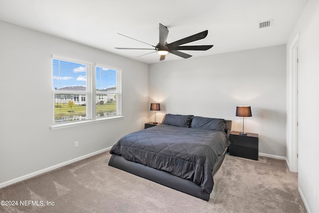 bedroom with light carpet and ceiling fan