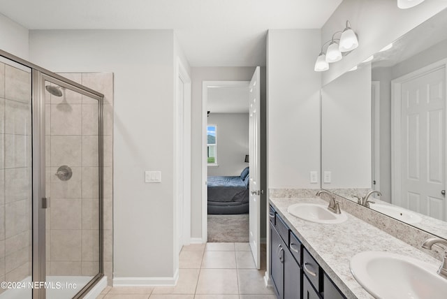 bathroom featuring vanity, tile patterned flooring, and a shower with door