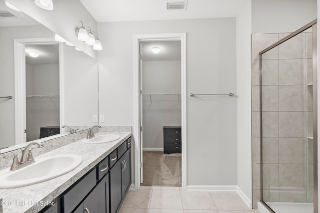 bathroom with vanity, tile patterned flooring, and a shower with door