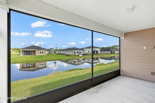 unfurnished sunroom with a water view