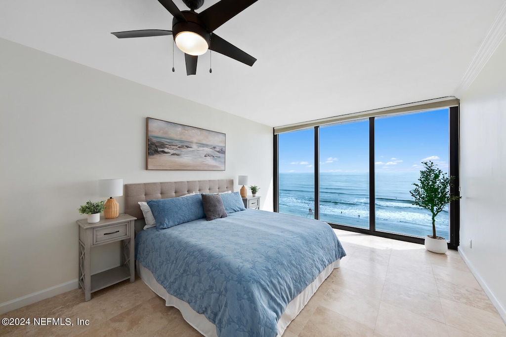 bedroom featuring a water view, ornamental molding, access to outside, ceiling fan, and expansive windows