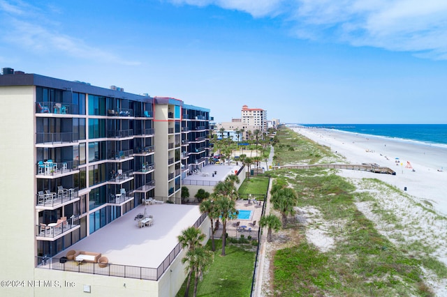 exterior space featuring a beach view and a water view