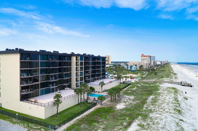 view of building exterior featuring a view of the beach and a water view