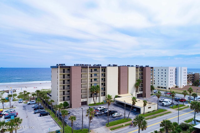 exterior space featuring a beach view and a water view