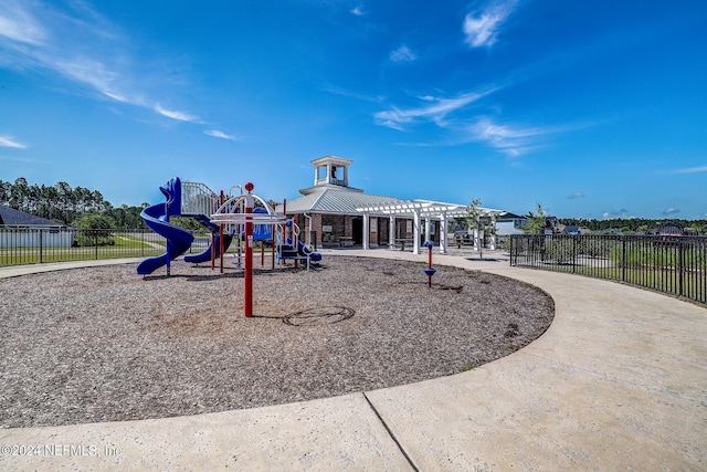 community playground featuring fence and a pergola