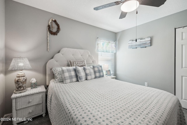 bedroom with ceiling fan and carpet flooring