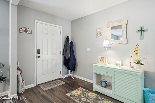 entryway with dark wood-type flooring and baseboards