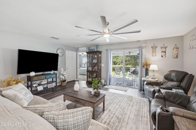 living area featuring wood finished floors, visible vents, and a ceiling fan