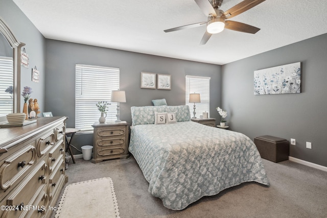 bedroom featuring a ceiling fan, light carpet, and baseboards