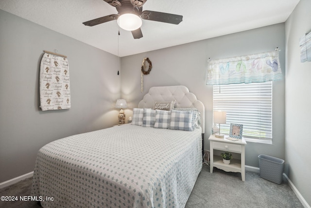 carpeted bedroom featuring a ceiling fan and baseboards