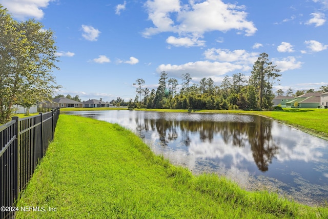 property view of water featuring fence