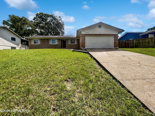 ranch-style house featuring brick siding, concrete driveway, an attached garage, fence, and a front lawn