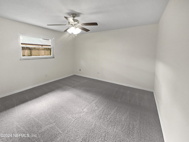 unfurnished room with carpet flooring, ceiling fan, and baseboards