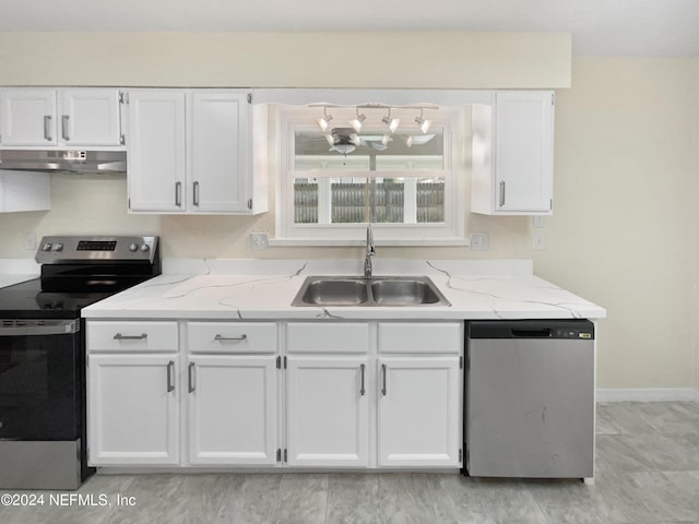 kitchen with appliances with stainless steel finishes, light stone countertops, under cabinet range hood, white cabinetry, and a sink