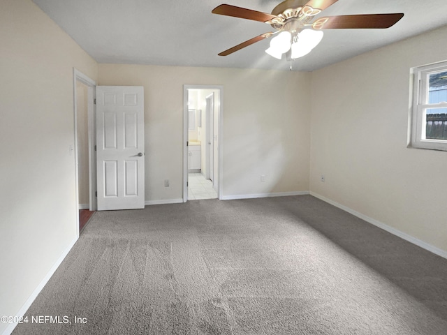 unfurnished bedroom with carpet, baseboards, and ensuite bathroom