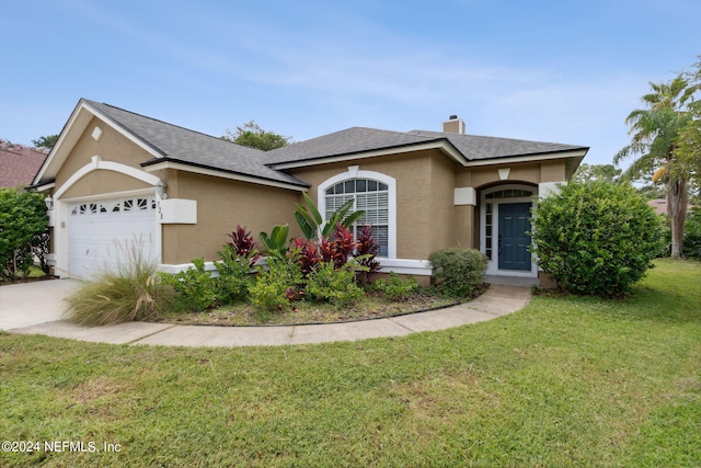 view of front of home with an attached garage, concrete driveway, stucco siding, a front lawn, and a chimney