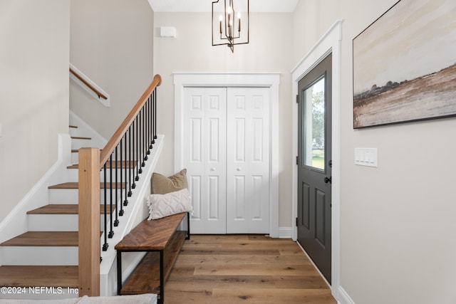 foyer featuring stairs, wood finished floors, and baseboards