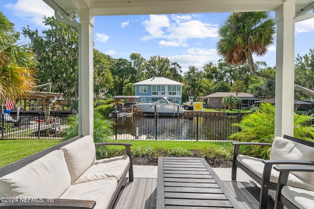 view of patio with a water view, fence, and outdoor lounge area