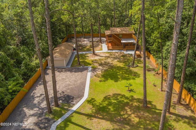 drone / aerial view featuring a wooded view