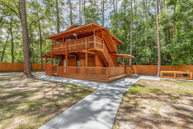 log home with a wooden deck