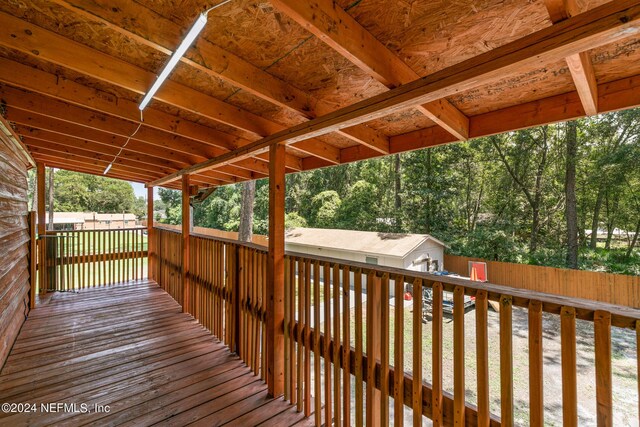 wooden terrace featuring a shed