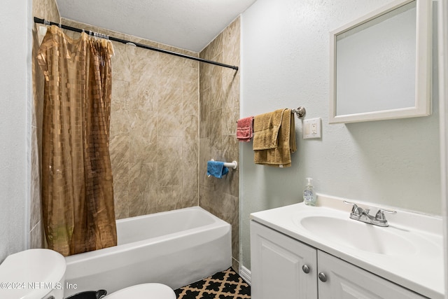 full bathroom with tile patterned floors, toilet, shower / bath combination with curtain, vanity, and a textured ceiling