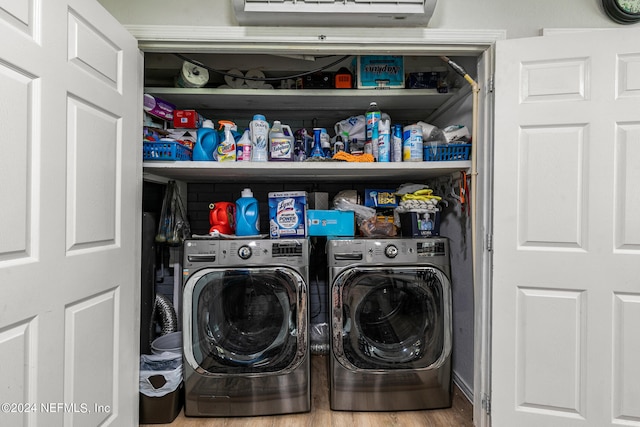 washroom with washer and dryer and light hardwood / wood-style floors