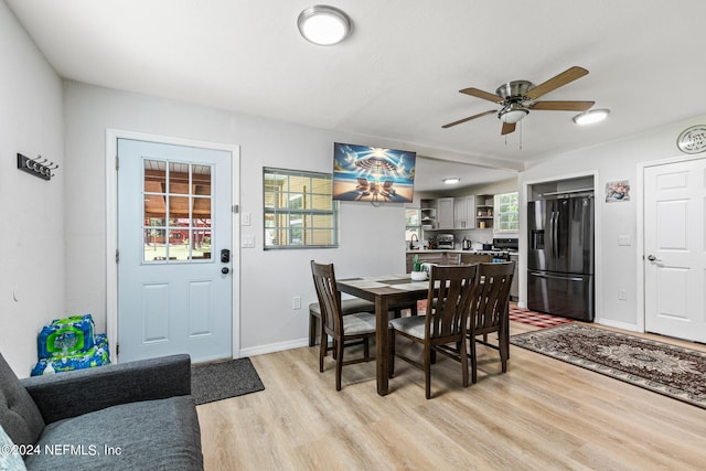 dining room with light wood-type flooring, plenty of natural light, sink, and ceiling fan