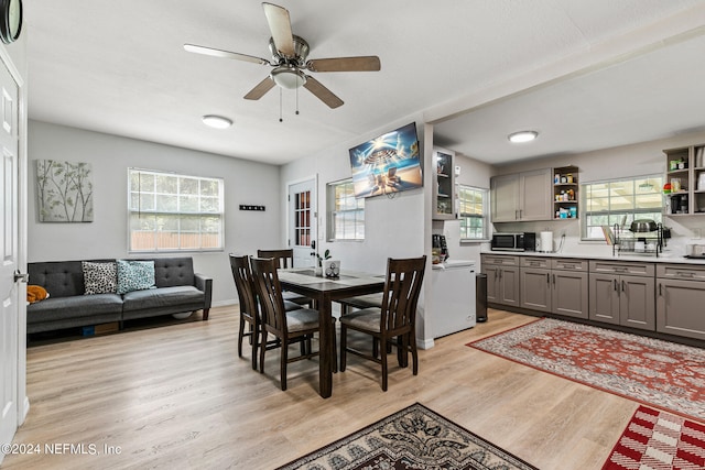 dining space featuring light wood-type flooring and ceiling fan