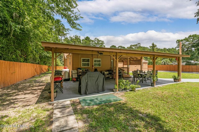 rear view of property with a lawn and a patio area