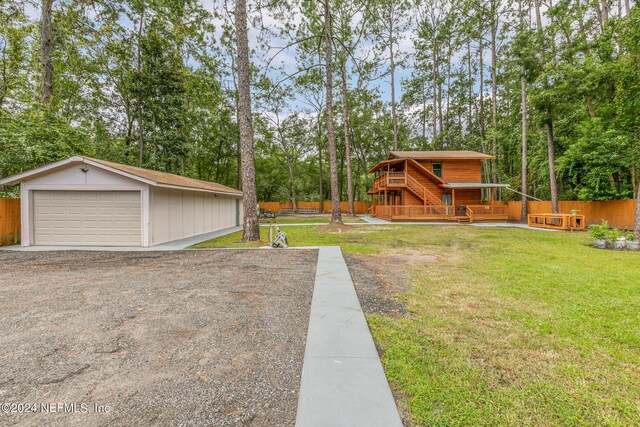 view of yard featuring a garage and an outdoor structure