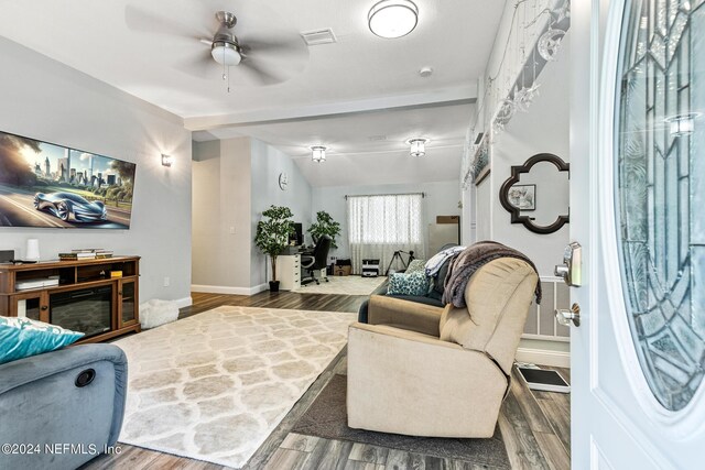 living room featuring lofted ceiling, ceiling fan, and wood-type flooring