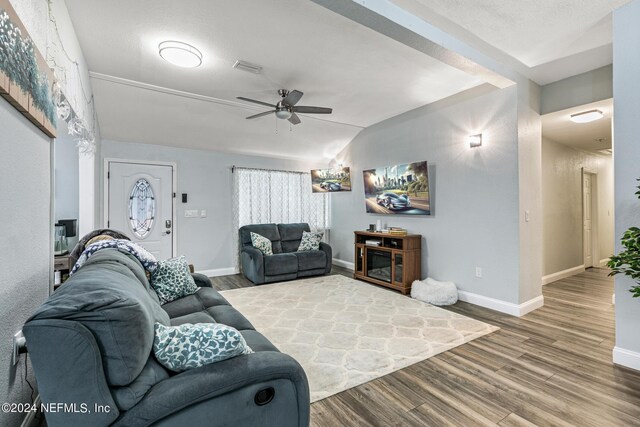 living room featuring vaulted ceiling, hardwood / wood-style floors, and ceiling fan