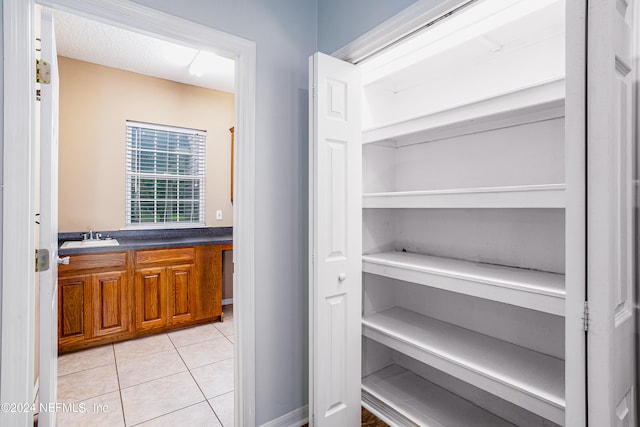 bathroom featuring tile patterned flooring and vanity