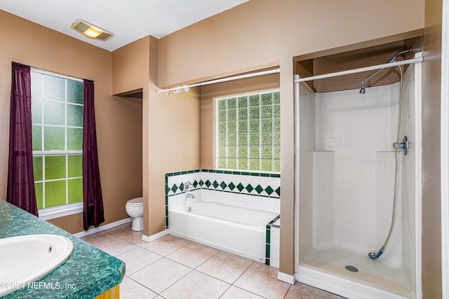 full bathroom with toilet, tile patterned floors, vanity, a textured ceiling, and independent shower and bath