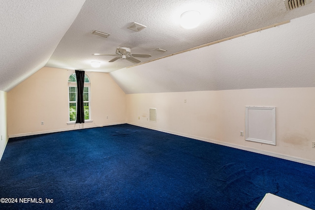 additional living space featuring ceiling fan, carpet floors, vaulted ceiling, and a textured ceiling