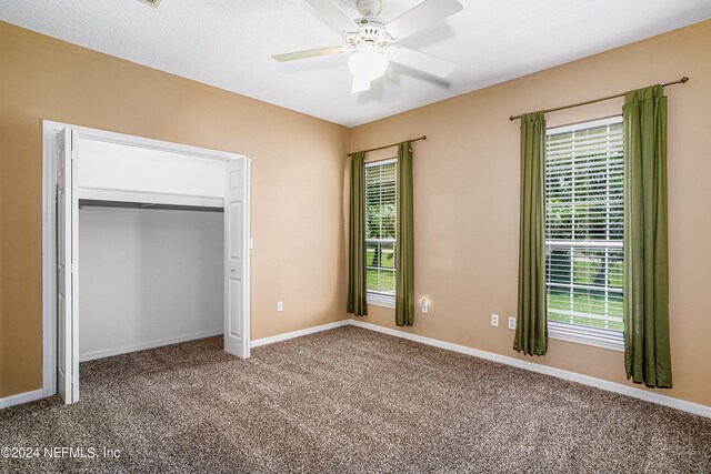 unfurnished bedroom with multiple windows, ceiling fan, and carpet