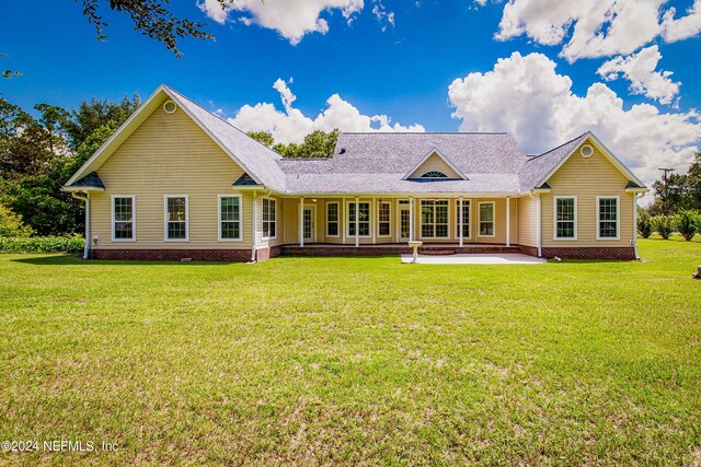 ranch-style house with a front yard and a patio