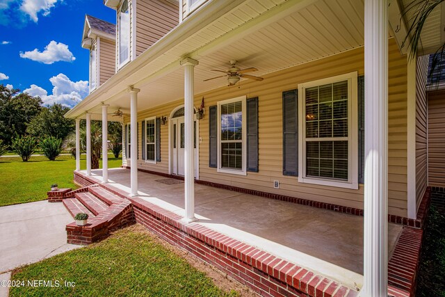 view of patio with ceiling fan and a porch