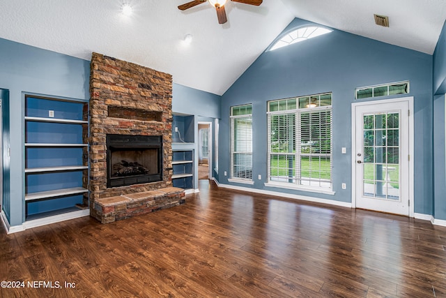 unfurnished living room with a textured ceiling, a fireplace, dark wood-type flooring, high vaulted ceiling, and ceiling fan