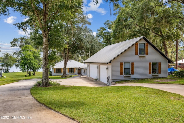 view of front of home with a garage and a front lawn