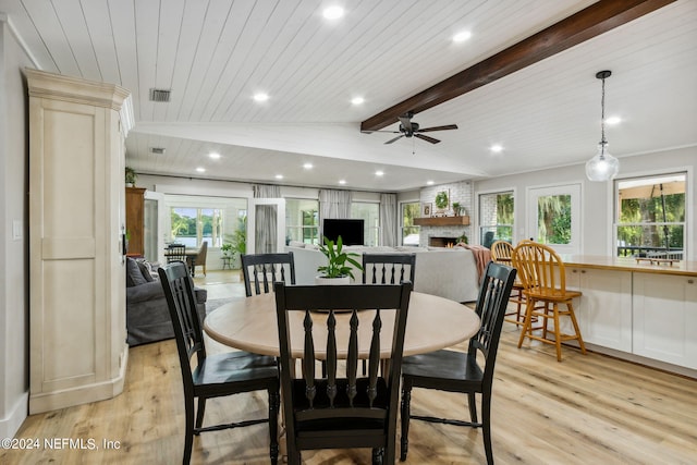 dining area with a fireplace, wood ceiling, ceiling fan, light wood-type flooring, and vaulted ceiling with beams