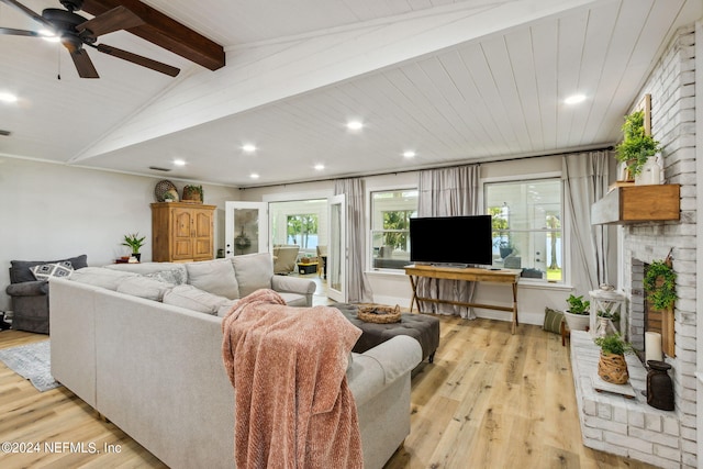 living room featuring a fireplace, wood ceiling, light hardwood / wood-style flooring, ceiling fan, and lofted ceiling with beams