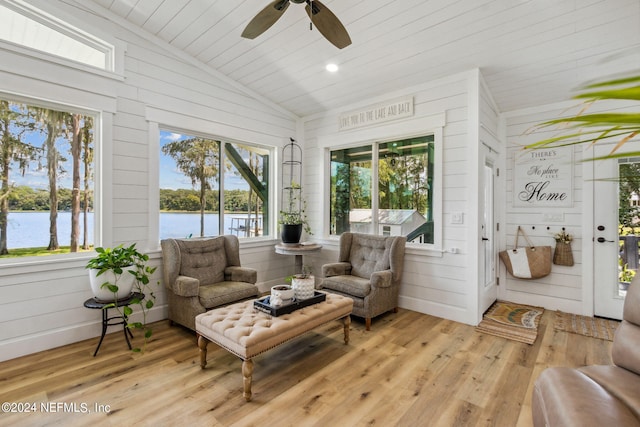 sunroom / solarium with a water view, ceiling fan, wooden ceiling, and vaulted ceiling