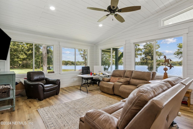 sunroom / solarium with lofted ceiling, ceiling fan, and wooden ceiling