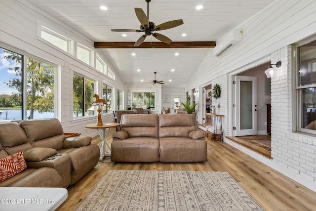 sunroom / solarium with ceiling fan, an AC wall unit, and vaulted ceiling with beams