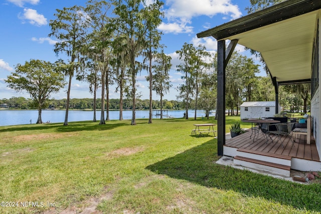 view of yard with a deck with water view