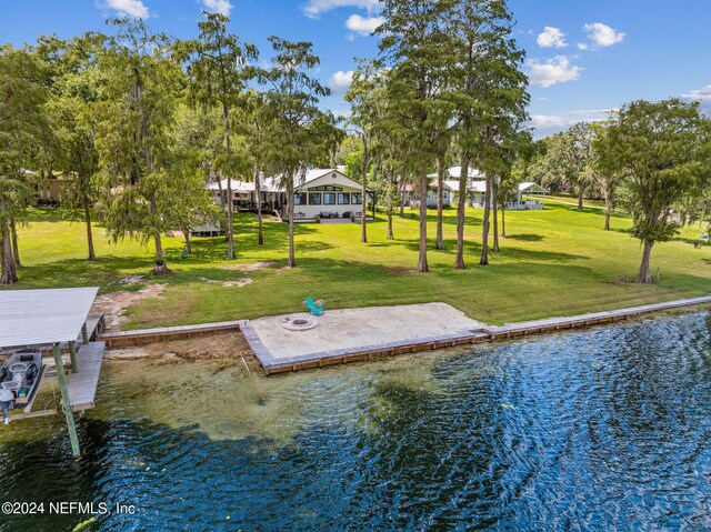 dock area with a water view and a lawn