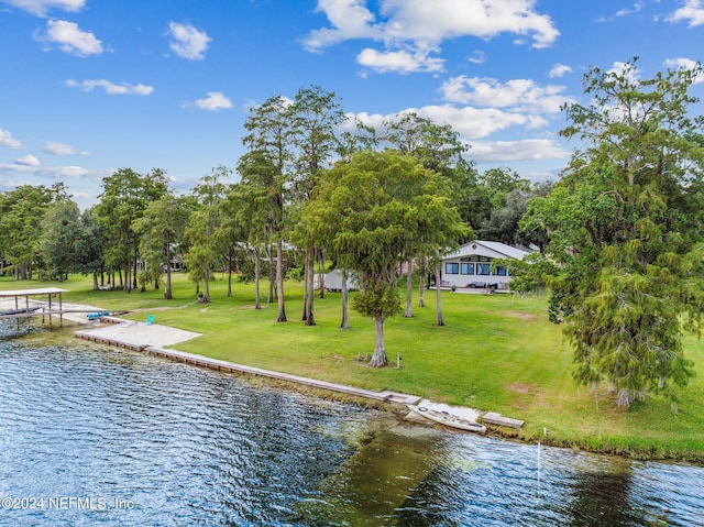 view of dock featuring a water view and a lawn