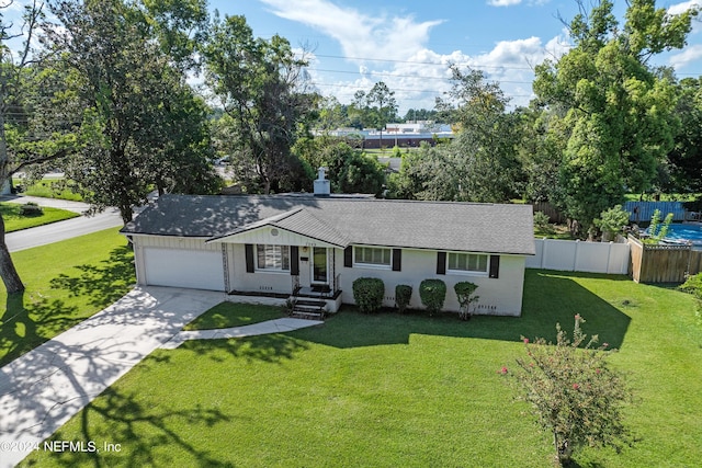 ranch-style house featuring a front yard and a garage